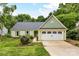 Charming home with green siding, a two-car garage and beautiful landscaping at 10213 Conistan Pl, Cornelius, NC 28031