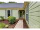 Inviting home entrance with well-maintained landscaping and a charming, light green exterior at 10213 Conistan Pl, Cornelius, NC 28031