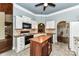 Charming kitchen featuring white cabinets, granite countertops, an island and stainless appliances at 10213 Conistan Pl, Cornelius, NC 28031