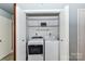 Laundry room closet with a washer and dryer and shelving above at 10213 Conistan Pl, Cornelius, NC 28031