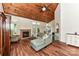 Bright living room with a wood-paneled vaulted ceiling, fireplace, and hardwood floors at 10213 Conistan Pl, Cornelius, NC 28031