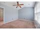 A bedroom with a ceiling fan, carpeted floors, a sloped ceiling, and a bright window for natural light at 11210 Northwoods Forest Dr, Charlotte, NC 28214