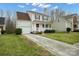 Charming home with manicured lawn, attached garage, and covered porch and lovely curb appeal at 11210 Northwoods Forest Dr, Charlotte, NC 28214