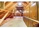 Large unfinished attic with exposed beams, wooden cabinetry, and lots of potential storage space at 1207 Chadbourne Ave, Concord, NC 28027