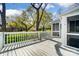 An outdoor deck is surrounded by a white railing, offering a serene view of the lush green lawn at 1207 Chadbourne Ave, Concord, NC 28027