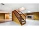Basement features carpeted stairs and a cozy area with a brick fireplace at 1207 Chadbourne Ave, Concord, NC 28027