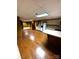Open basement area featuring hardwood flooring, cabinets, and a kitchenette at 1207 Chadbourne Ave, Concord, NC 28027