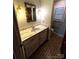 Bathroom featuring marble sink vanity, neutral walls and brown and tan floors, and vintage sconces at 1207 Chadbourne Ave, Concord, NC 28027