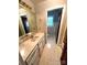 Bathroom featuring single marble sink vanity, neutral walls and white and tan floors at 1207 Chadbourne Ave, Concord, NC 28027