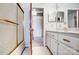 Bright bathroom with a shower, double vanity and a glimpse into an adjacent room with a closet at 1207 Chadbourne Ave, Concord, NC 28027