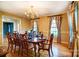 Traditional dining room with wood floors, chandelier, and a large table set for eight at 1207 Chadbourne Ave, Concord, NC 28027