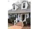 Charming home featuring dormer windows, brick walkway and blue shutters, offering classic curb appeal at 1207 Chadbourne Ave, Concord, NC 28027