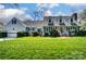 Charming two-story home with a manicured lawn and blue shutters at 1207 Chadbourne Ave, Concord, NC 28027