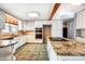 Bright kitchen featuring white cabinets, granite countertops, tile floors, and stainless steel appliances at 1207 Chadbourne Ave, Concord, NC 28027