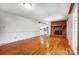 Large living room with hardwood floors, a brick fireplace, and open access to the kitchen at 1207 Chadbourne Ave, Concord, NC 28027