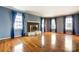 Open living room with hardwood floors, a cozy fireplace, and ample natural light at 1207 Chadbourne Ave, Concord, NC 28027