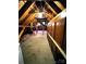Unfinished attic space featuring exposed beams, wooden cabinetry, and ample storage solutions at 1207 Chadbourne Ave, Concord, NC 28027