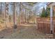 View of the backyard with mature trees, featuring a section of the wooden deck at 125 Cherokee Dr, Mooresville, NC 28117