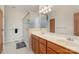 Bathroom featuring double vanity, tiled floor, and seamless glass shower doors, offering a luxurious and stylish space at 125 Cherokee Dr, Mooresville, NC 28117