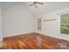 Inviting bedroom with warm hardwood floors and a ceiling fan, providing a bright and comfortable space at 125 Cherokee Dr, Mooresville, NC 28117