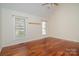 Inviting bedroom with warm hardwood floors and a ceiling fan, providing a bright and comfortable space at 125 Cherokee Dr, Mooresville, NC 28117