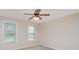 Bedroom with two large windows, neutral walls, carpet and ceiling fan at 125 Cherokee Dr, Mooresville, NC 28117