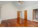 Spacious bedroom with gleaming hardwood floors, a vaulted ceiling, and natural light from multiple doors at 125 Cherokee Dr, Mooresville, NC 28117