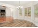 Bright dining area features large windows, modern chandelier, and views of the outdoor deck at 125 Cherokee Dr, Mooresville, NC 28117