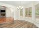 Bright dining area features large windows, modern chandelier, and views of the outdoor deck at 125 Cherokee Dr, Mooresville, NC 28117