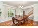 Bright dining room featuring a large window, hardwood floors, and an elegant chandelier at 125 Cherokee Dr, Mooresville, NC 28117