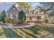Charming two-story home featuring brick accents, complemented by a well-maintained lawn and mature trees at 125 Cherokee Dr, Mooresville, NC 28117