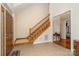 Bright foyer showcasing tile flooring, a wooden staircase, and an open doorway leading to the living spaces at 125 Cherokee Dr, Mooresville, NC 28117