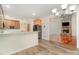 Open-concept kitchen with granite counters and stainless steel appliances, leading into cozy living area with stone fireplace at 125 Cherokee Dr, Mooresville, NC 28117