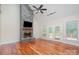 Bright living room with stone fireplace, hardwood floors, and access to a deck at 125 Cherokee Dr, Mooresville, NC 28117