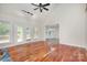 Bright living room area with hardwood floors, many windows, and access to a deck at 125 Cherokee Dr, Mooresville, NC 28117