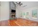 Bright living room with stone fireplace, hardwood floors, and access to a deck at 125 Cherokee Dr, Mooresville, NC 28117