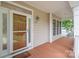 Inviting front porch featuring wood flooring, bright windows, and a welcoming door with decorative glass at 125 Cherokee Dr, Mooresville, NC 28117