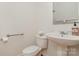 Clean powder room with pedestal sink, modern faucet, and convenient grab bar for accessibility at 125 Cherokee Dr, Mooresville, NC 28117