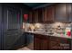 Finished basement bar with custom cabinets, bar fridge and sink, and Star Wars themed decor at 15309 Guthrie Dr, Huntersville, NC 28078