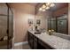 A stylish bathroom features granite counters, dual sinks, framed mirrors, and a glass enclosed shower at 15309 Guthrie Dr, Huntersville, NC 28078