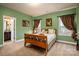 A charming bedroom features soft green walls, hardwood floors, and windows, creating a welcoming retreat at 15309 Guthrie Dr, Huntersville, NC 28078