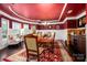 Elegant dining room with dark wood floors, a red ceiling, and ample natural light at 15309 Guthrie Dr, Huntersville, NC 28078