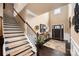 Inviting foyer featuring hardwood floors, elegant staircase, and high ceilings at 15309 Guthrie Dr, Huntersville, NC 28078