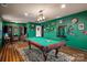 Spacious game room with a pool table, hardwood floors, and a decorative overhead light fixture at 15309 Guthrie Dr, Huntersville, NC 28078