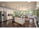 Large kitchen featuring an island, stainless steel appliances, breakfast area, and wood floors at 15309 Guthrie Dr, Huntersville, NC 28078