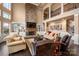 Open-concept living area with stone fireplace, built-in shelving, and plenty of natural light at 15309 Guthrie Dr, Huntersville, NC 28078