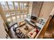Sun-drenched living area features a soaring stone fireplace, floor-to-ceiling windows, and stylish furnishings at 15309 Guthrie Dr, Huntersville, NC 28078