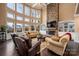 Bright living room with a soaring ceiling, stone fireplace, and large windows at 15309 Guthrie Dr, Huntersville, NC 28078