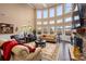 Spacious living room featuring hardwood floors, large windows, and comfortable seating at 15309 Guthrie Dr, Huntersville, NC 28078