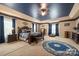 Spacious primary bedroom with tray ceiling, sitting area, and custom details at 15309 Guthrie Dr, Huntersville, NC 28078